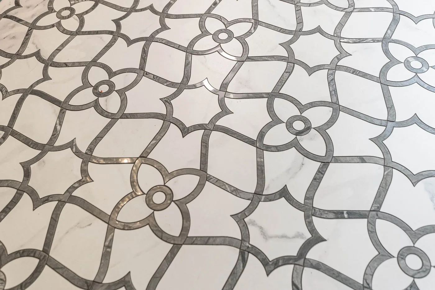 Marble mosaic floor tile set in a repeating pattern