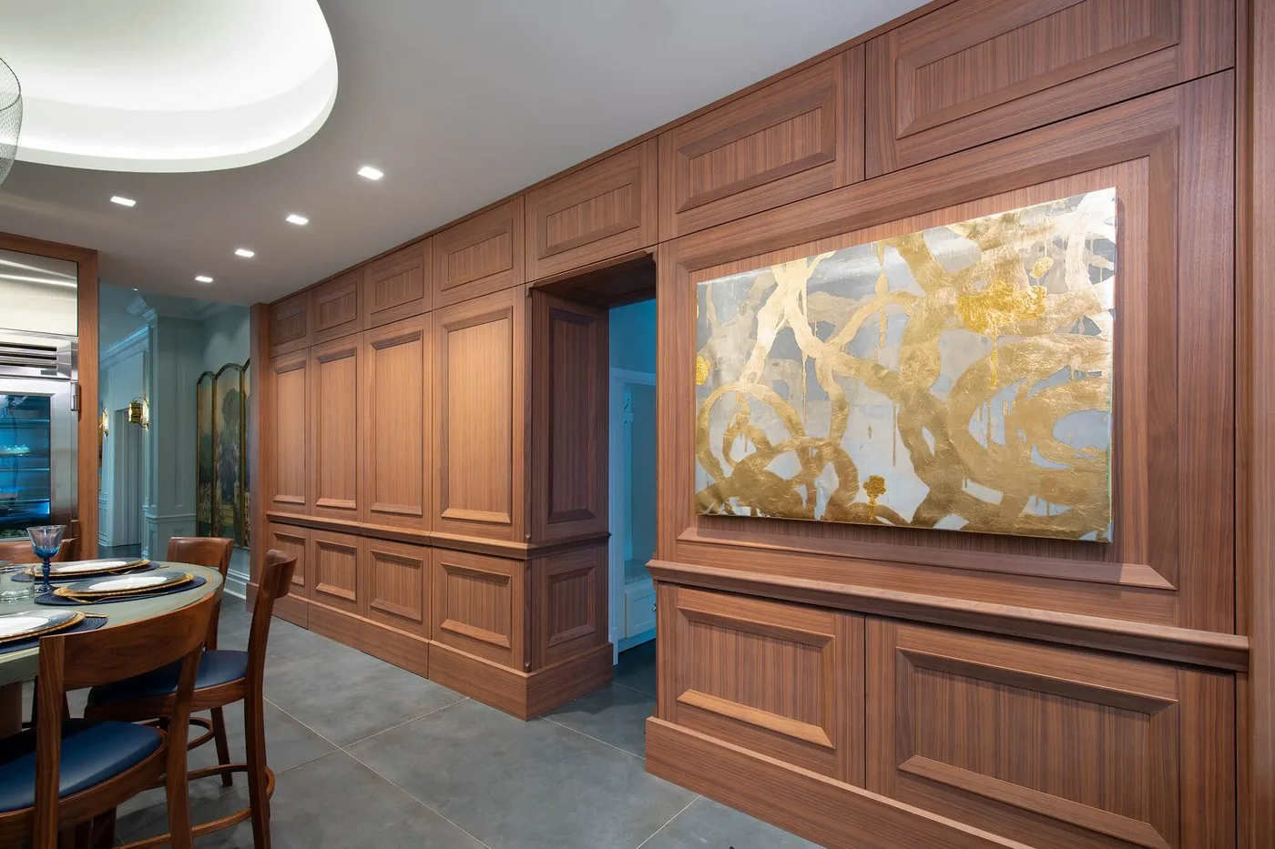 Wood paneled wall with a picture light and fitted trim