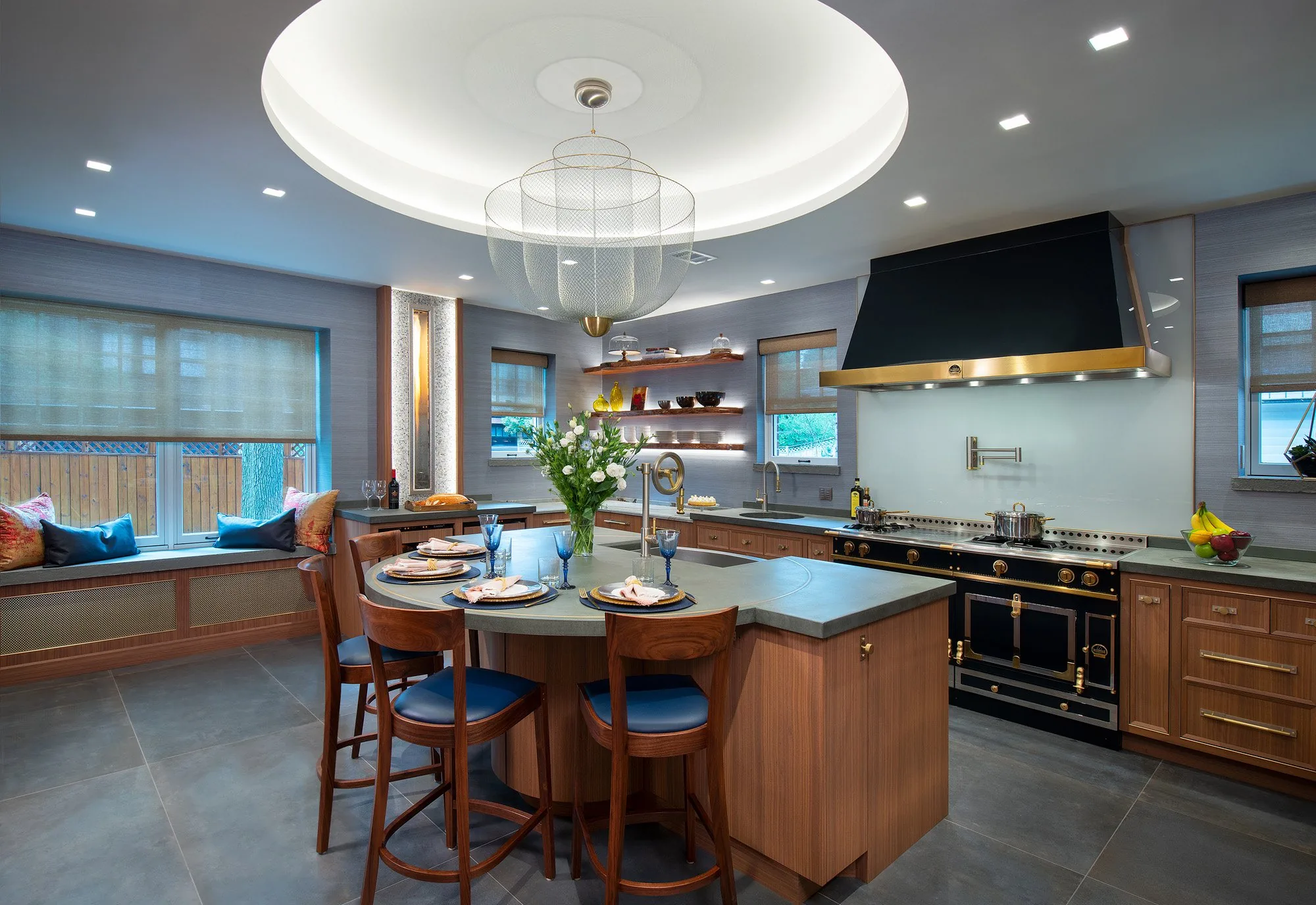 Renovated kitchen with walnut cabinetry, a painted island and a black range under a custom hood