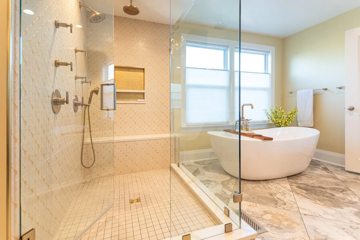 Freestanding tub beside a glass shower