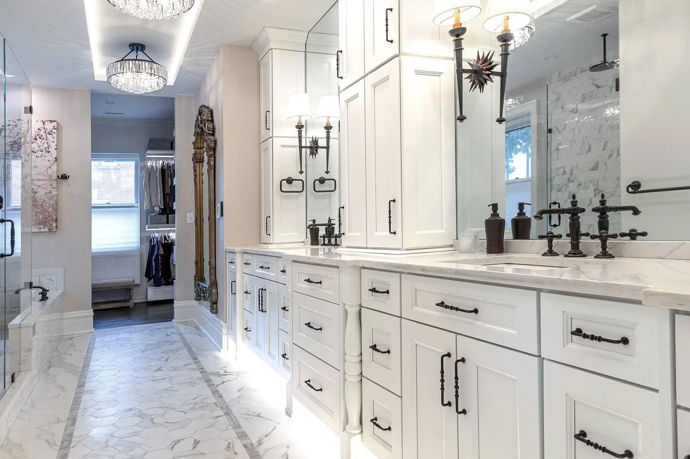Long marble bathroom with a run of cabinetry and sconces