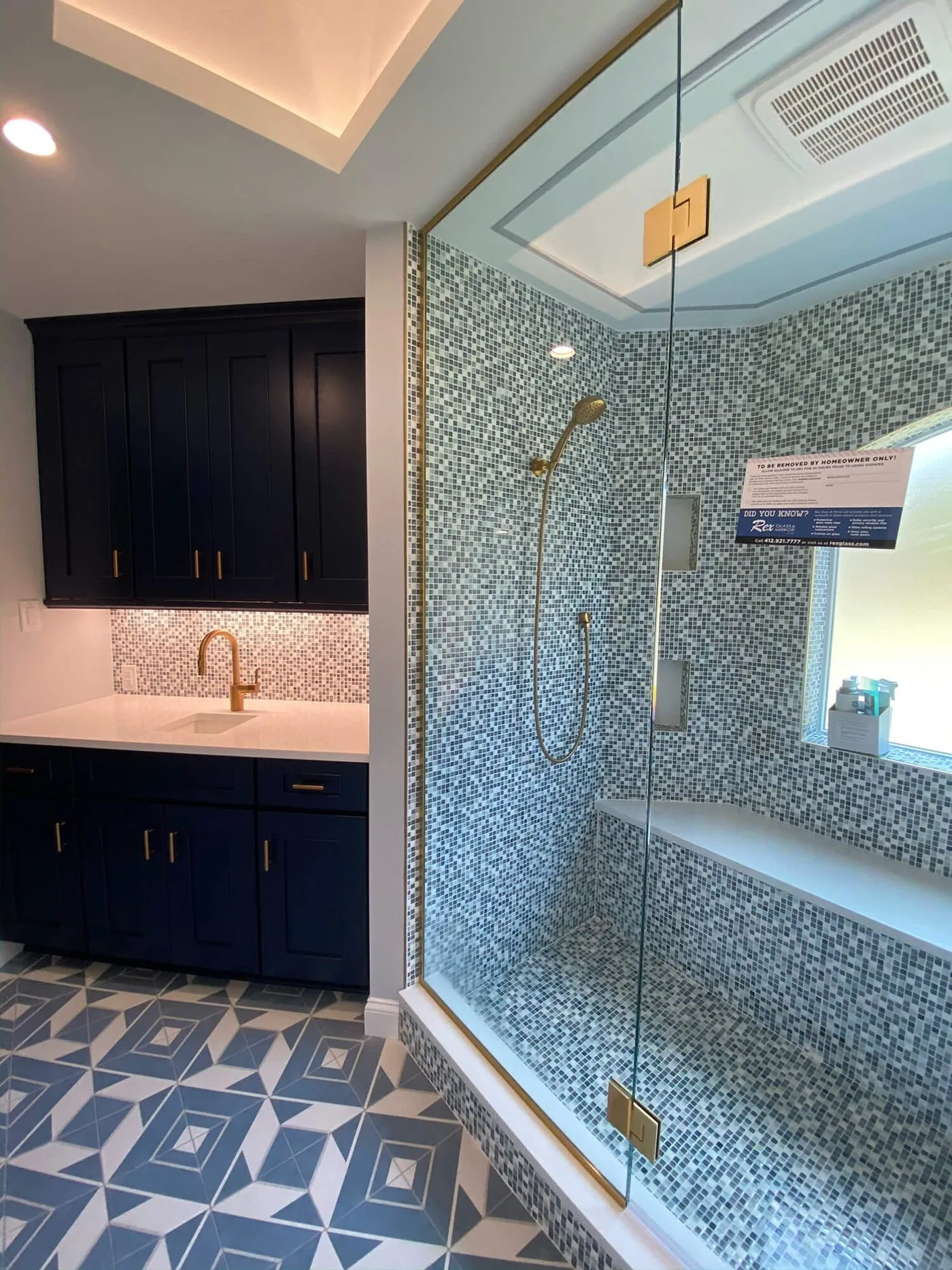 Shower with mosaic tile and a built-in bench