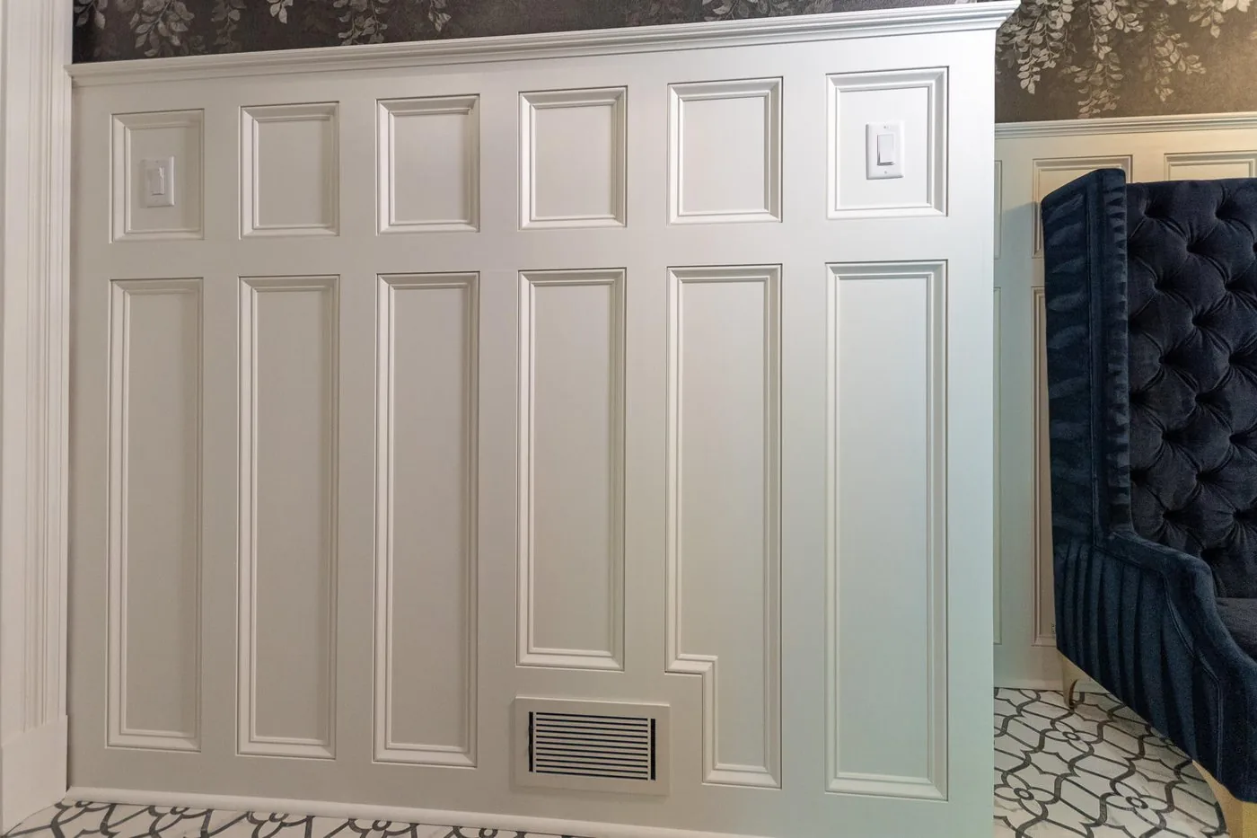 Painted wall paneling with a fitted floor vent
