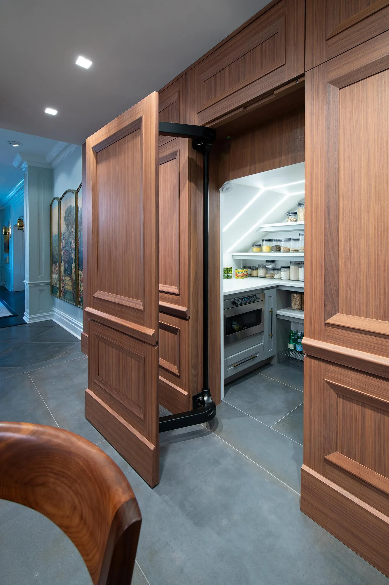Walnut paneling with a concealed door standing open