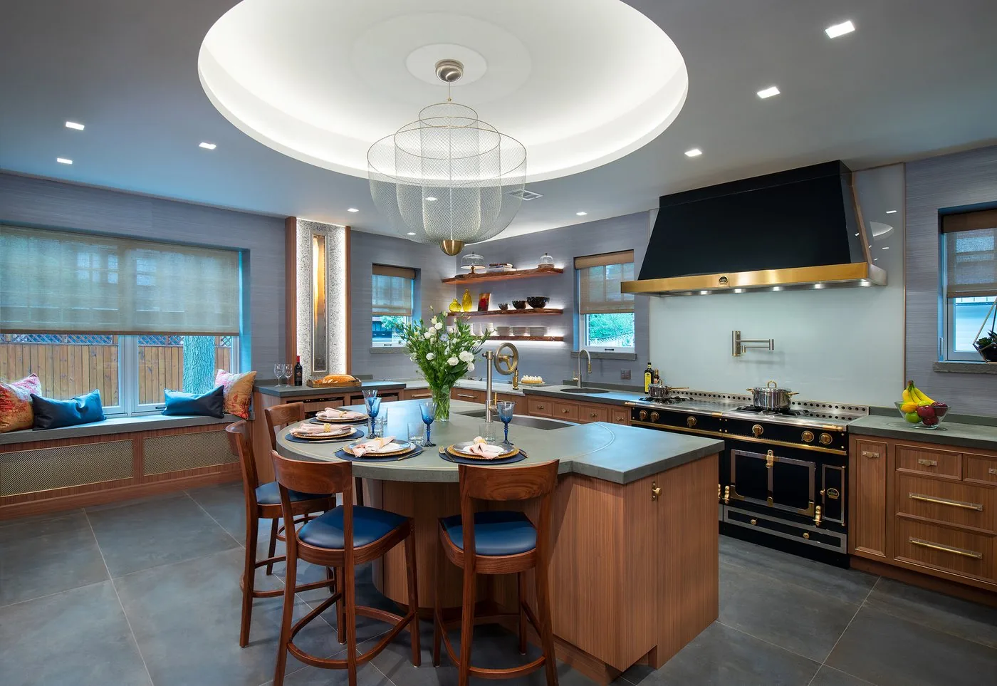 Kitchen with walnut cabinetry, a painted island and a black range