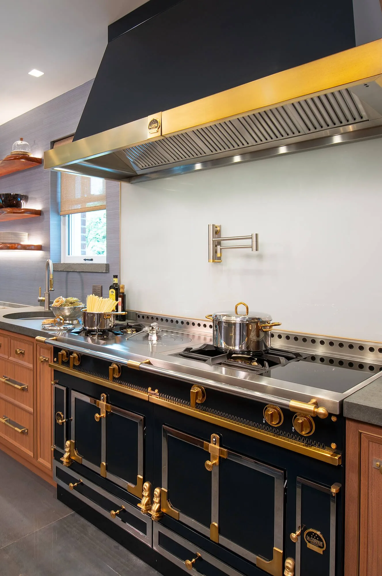 Kitchen range wall with a custom hood and cabinetry