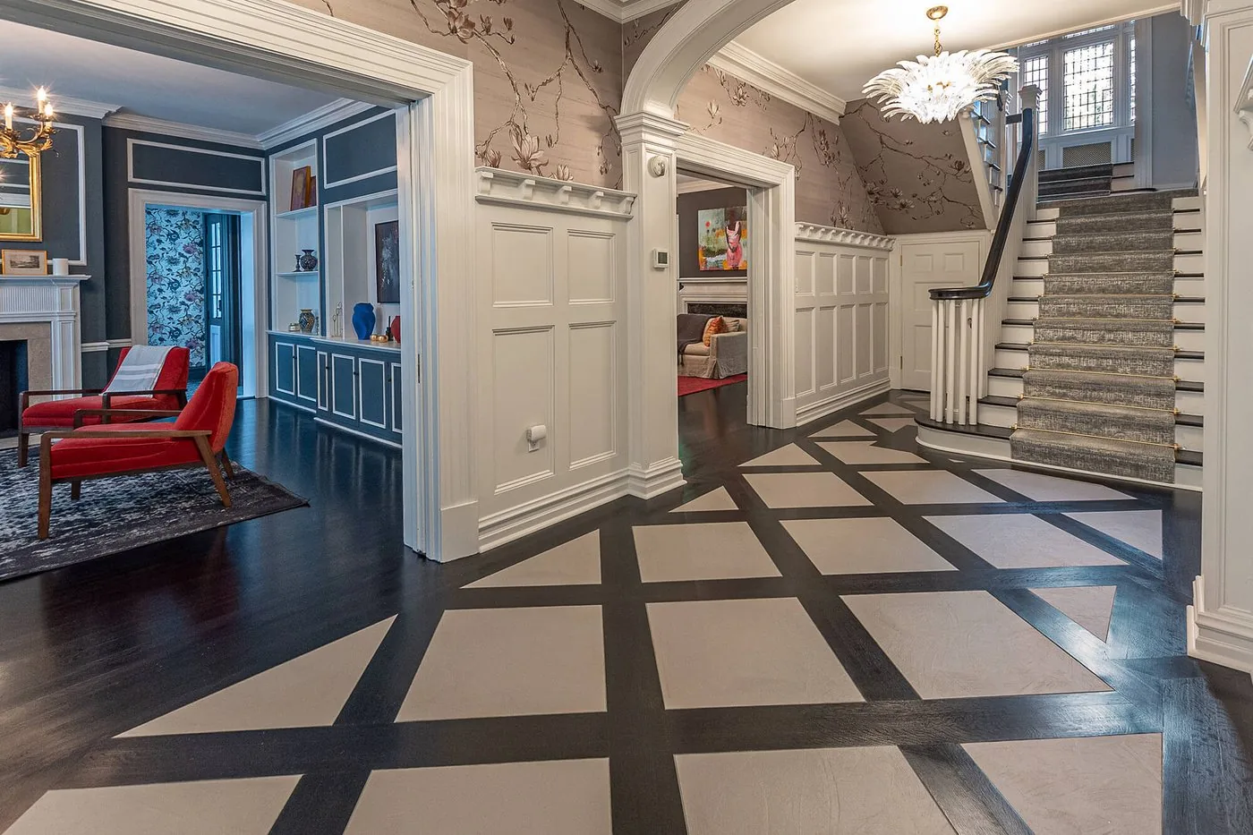 Hall with a graphic floor and a stair beyond
